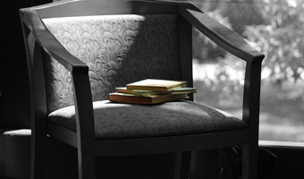  Chair in Black and white with literature books on it. 